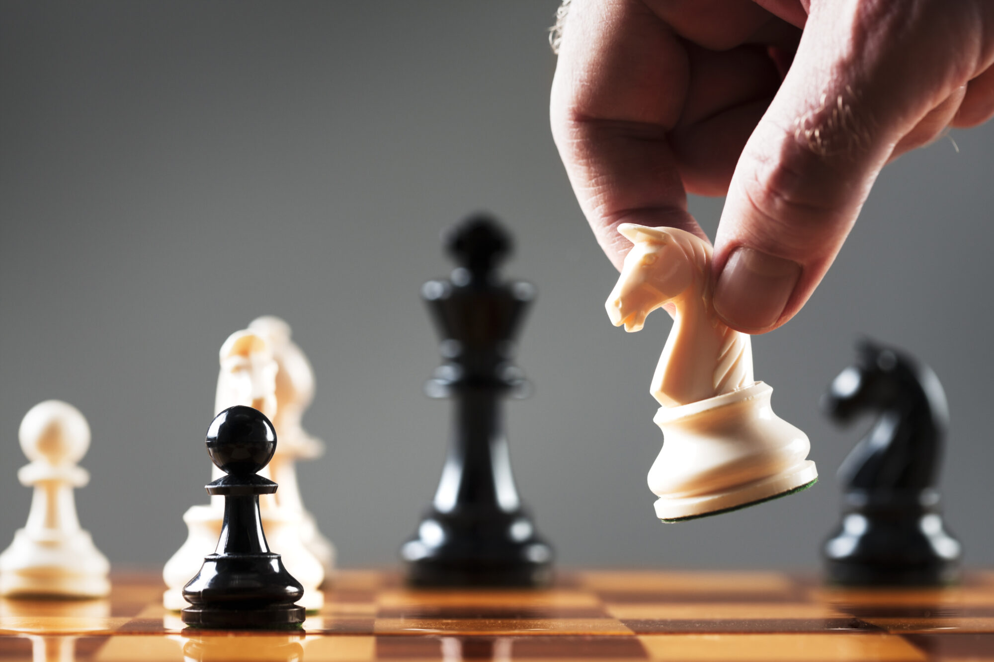 Strategy - hand moving a chess piece