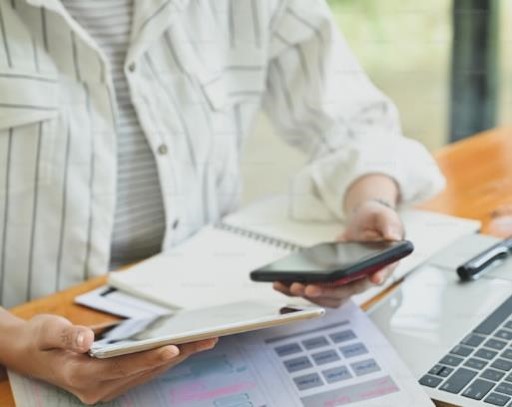 person holding multiple electronic devices